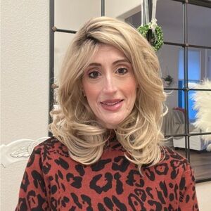 Synthetic blonde wig with dark roots.